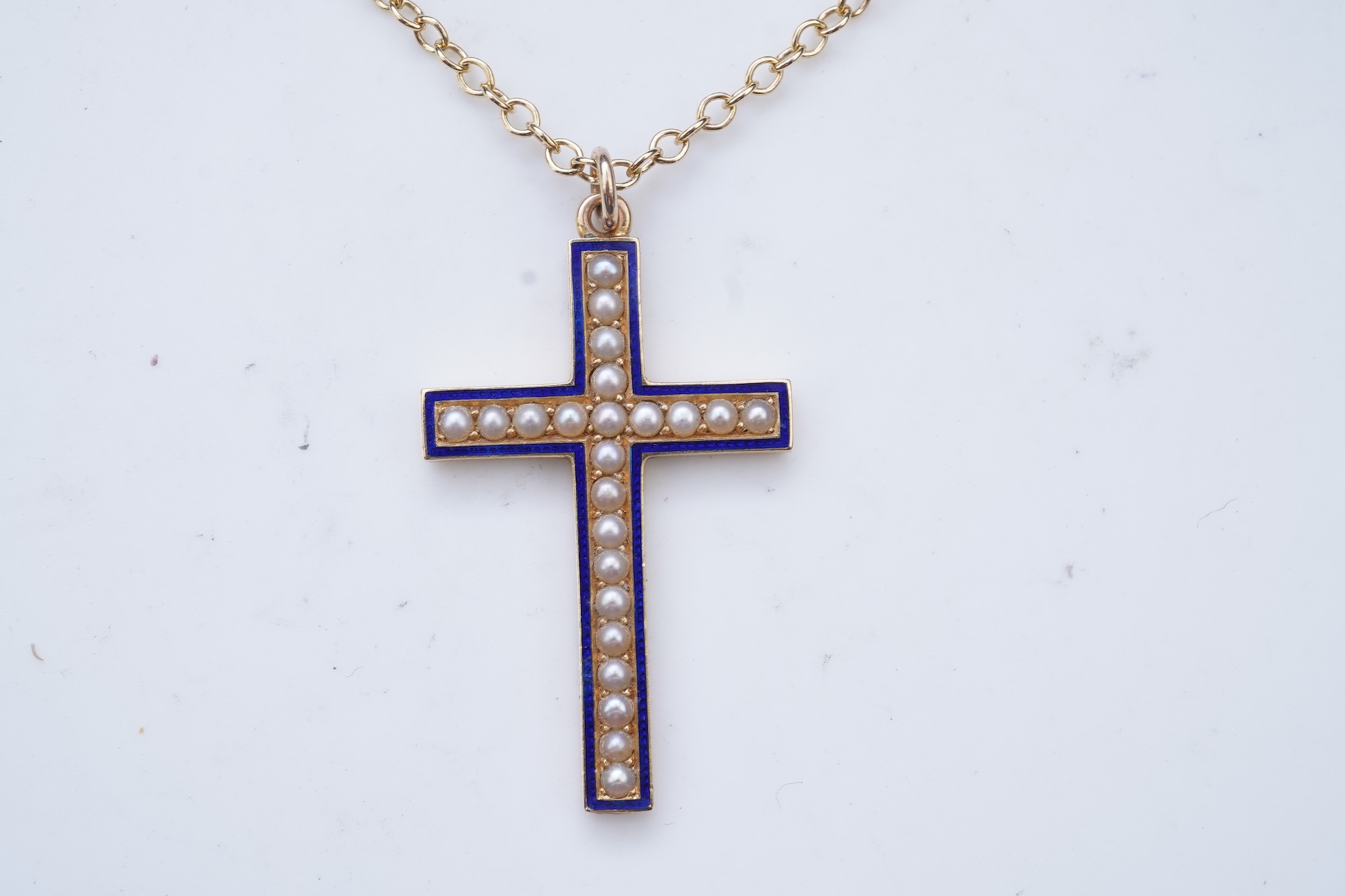 An Edwardian pearl and enamel cross and chain, early 20th century